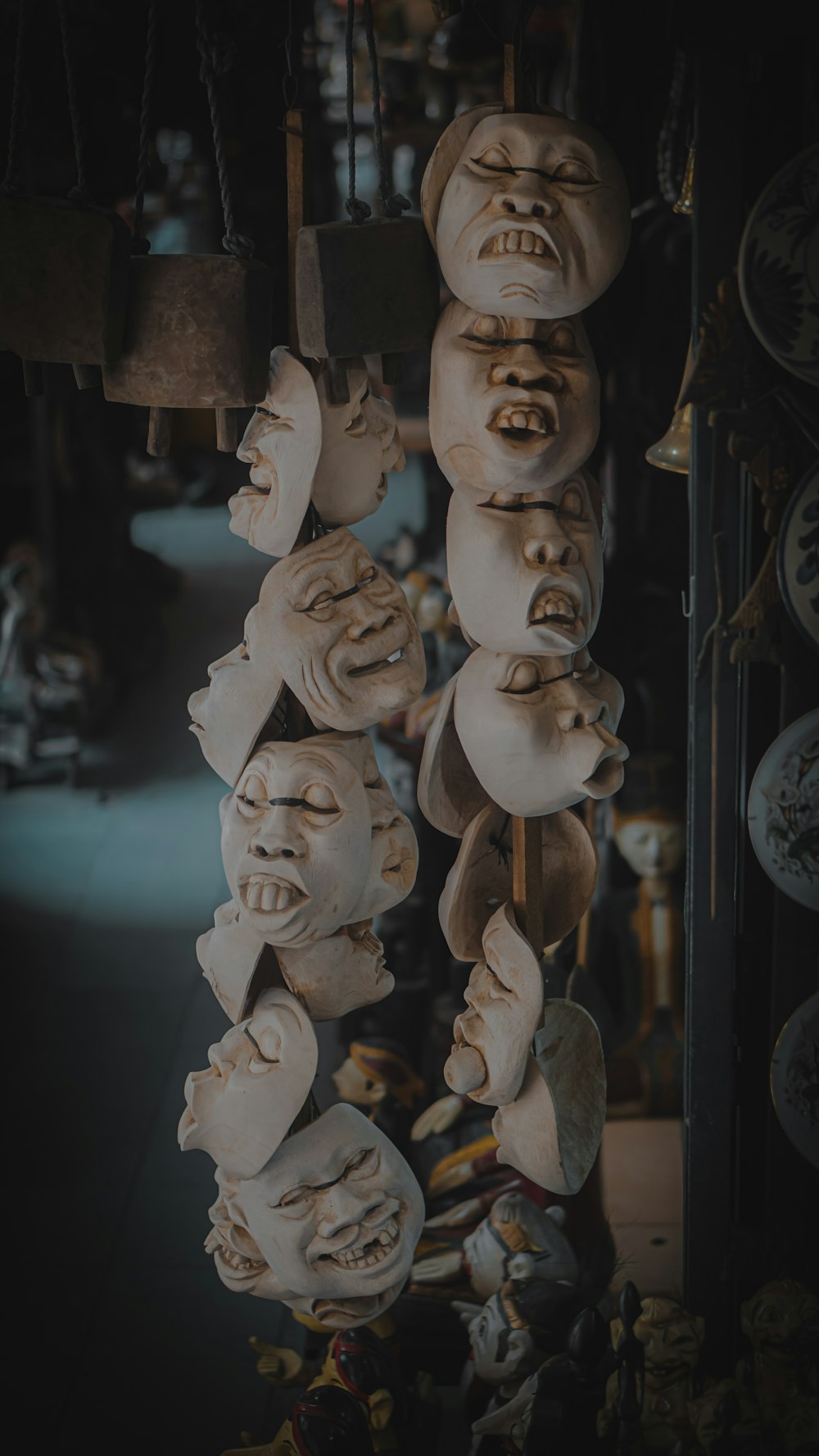 a group of masks hanging from a ceiling