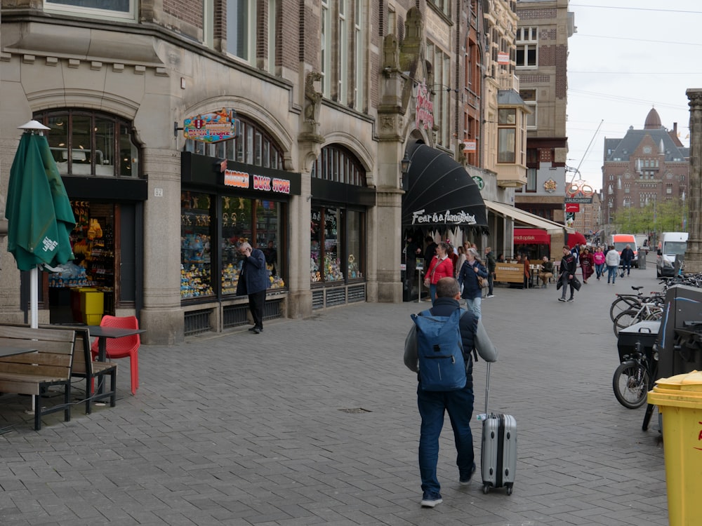 a person with a suitcase on a city street