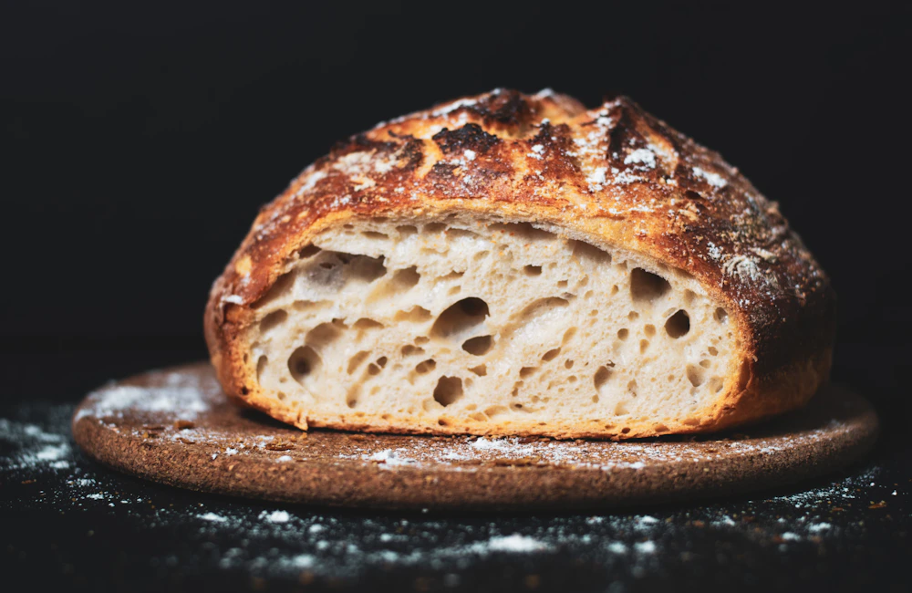 Halved sourdough loaf showing an open airy crumb