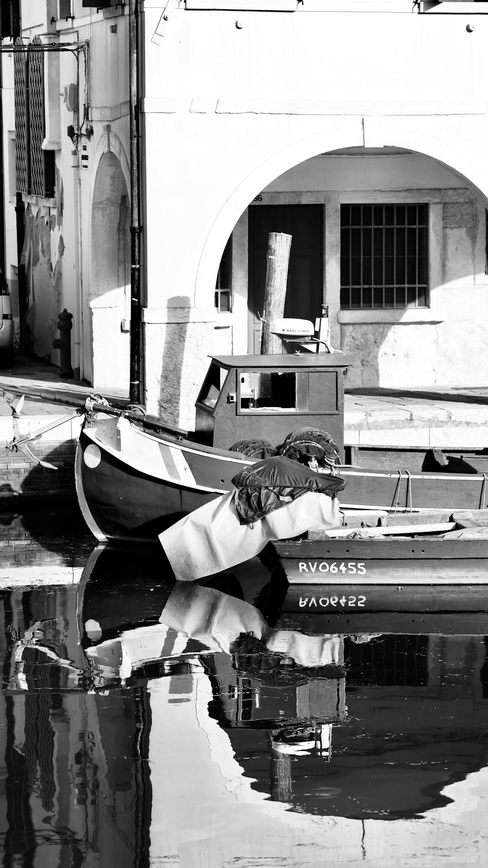 a black and white photo of a boat in the water