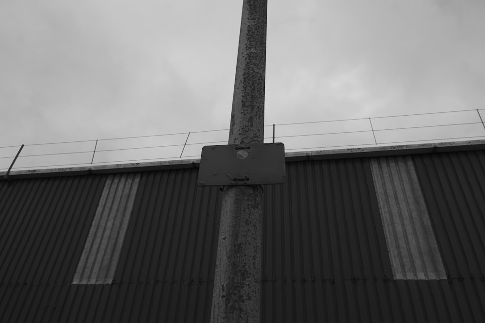 a tall metal pole with a sign on top of it