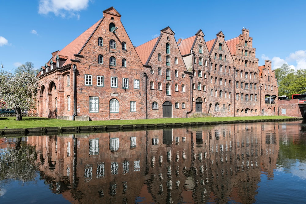 a large brick building sitting next to a body of water