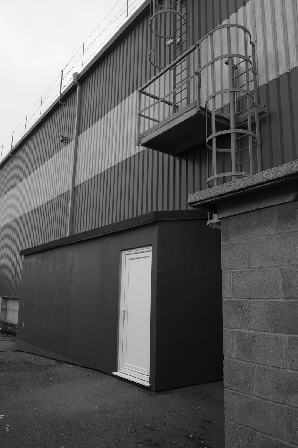 a black and white photo of a building with a fire escape