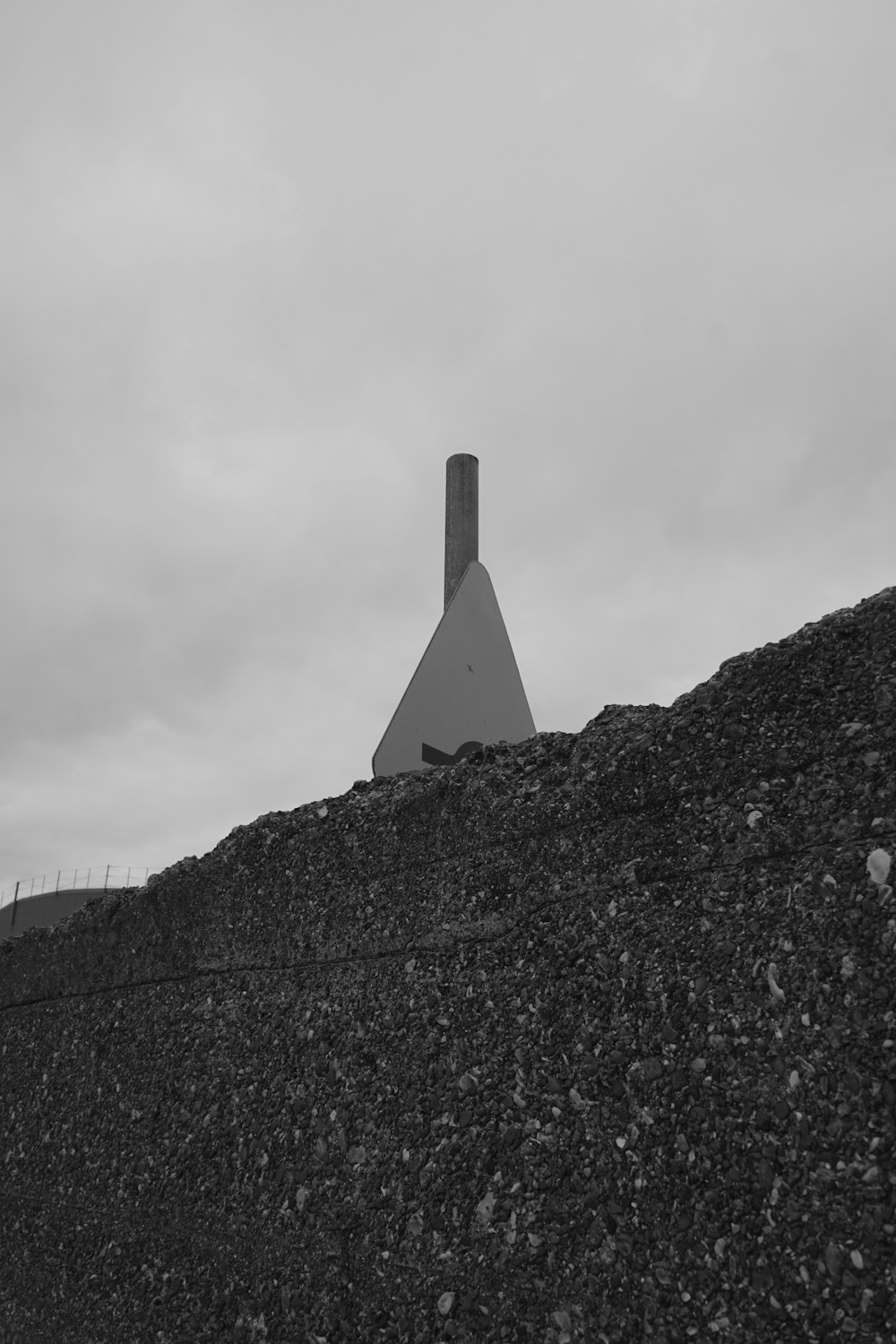 a black and white photo of a building on a hill