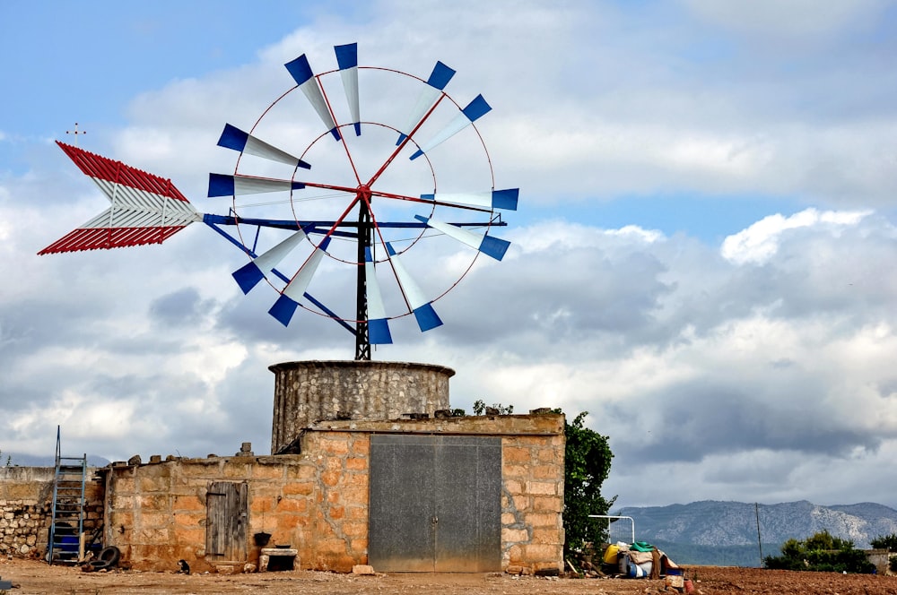 a windmill sitting on top of a stone building