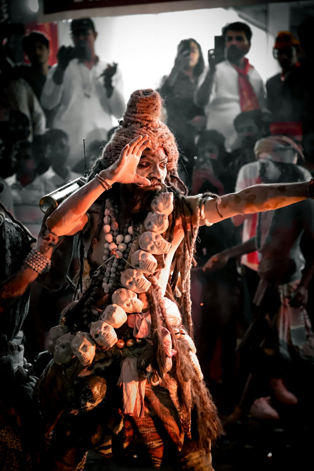 a man with dreadlocks on his head and arms in front of a crowd