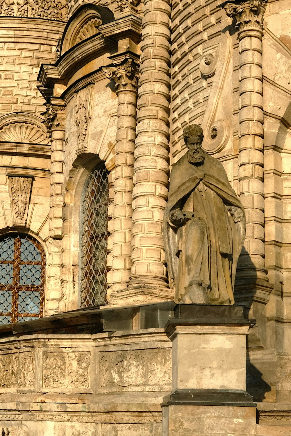 a statue of a monk in front of a building