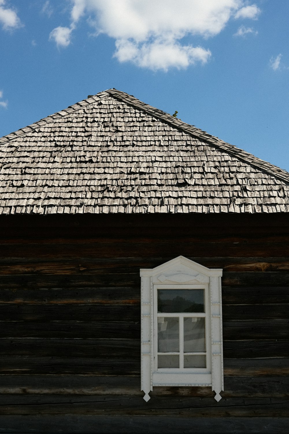 a window on the side of a wooden building