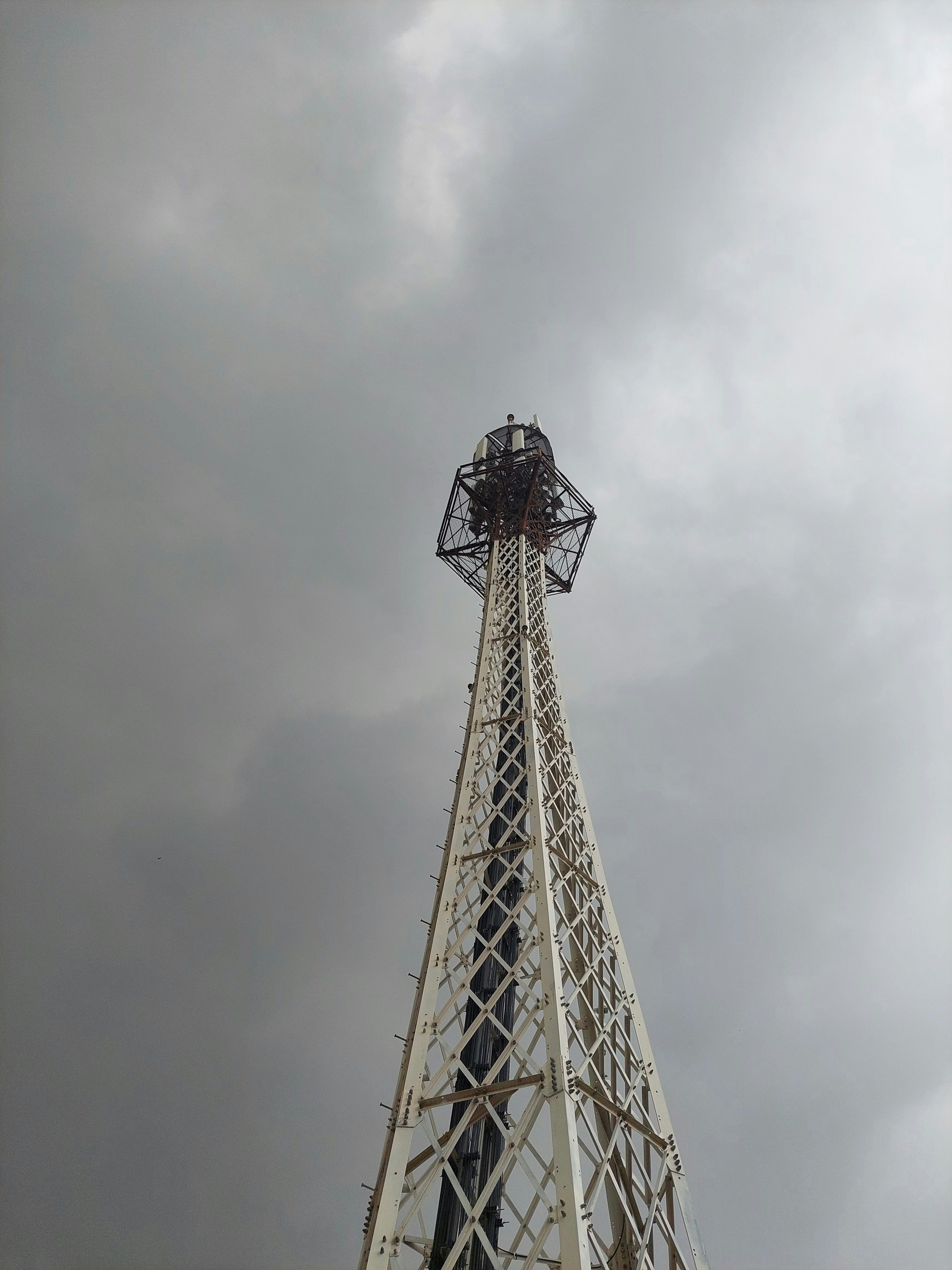 a tall metal tower with a sky background