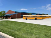 a yellow school bus parked in front of a building