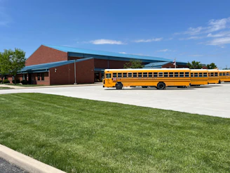 a yellow school bus parked in front of a building