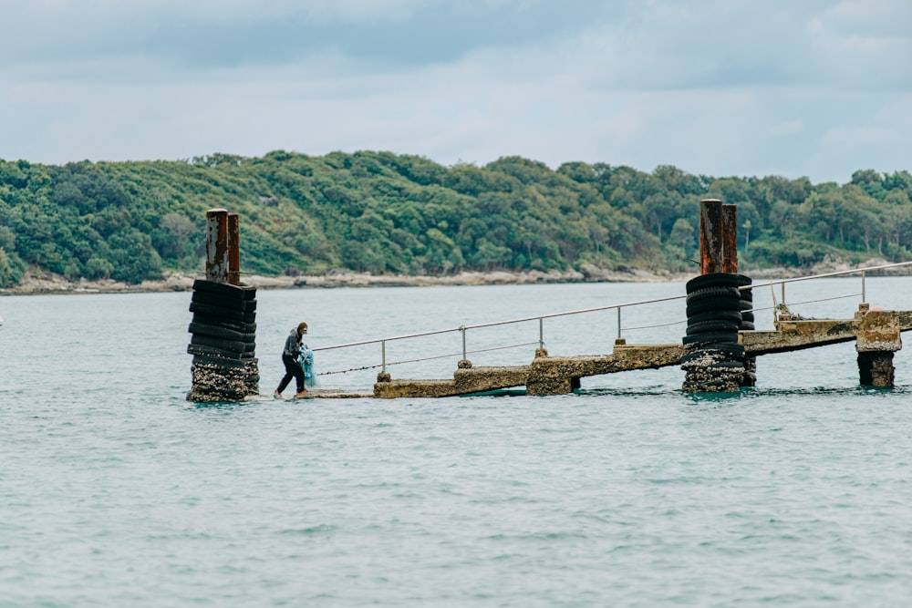 a man walking across a large body of water