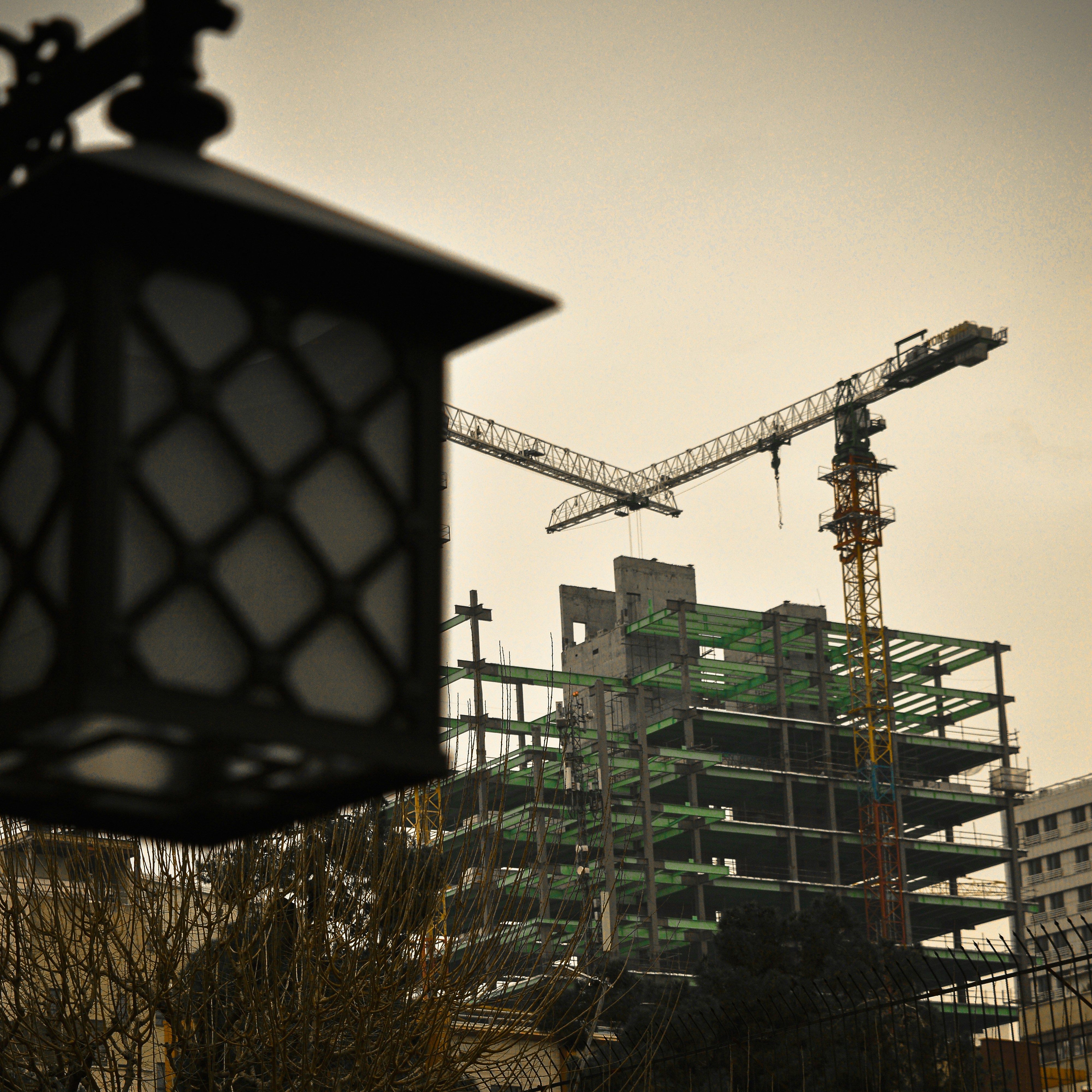 a building under construction with a crane in the background