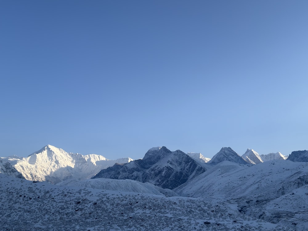 a view of a mountain range with snow on it