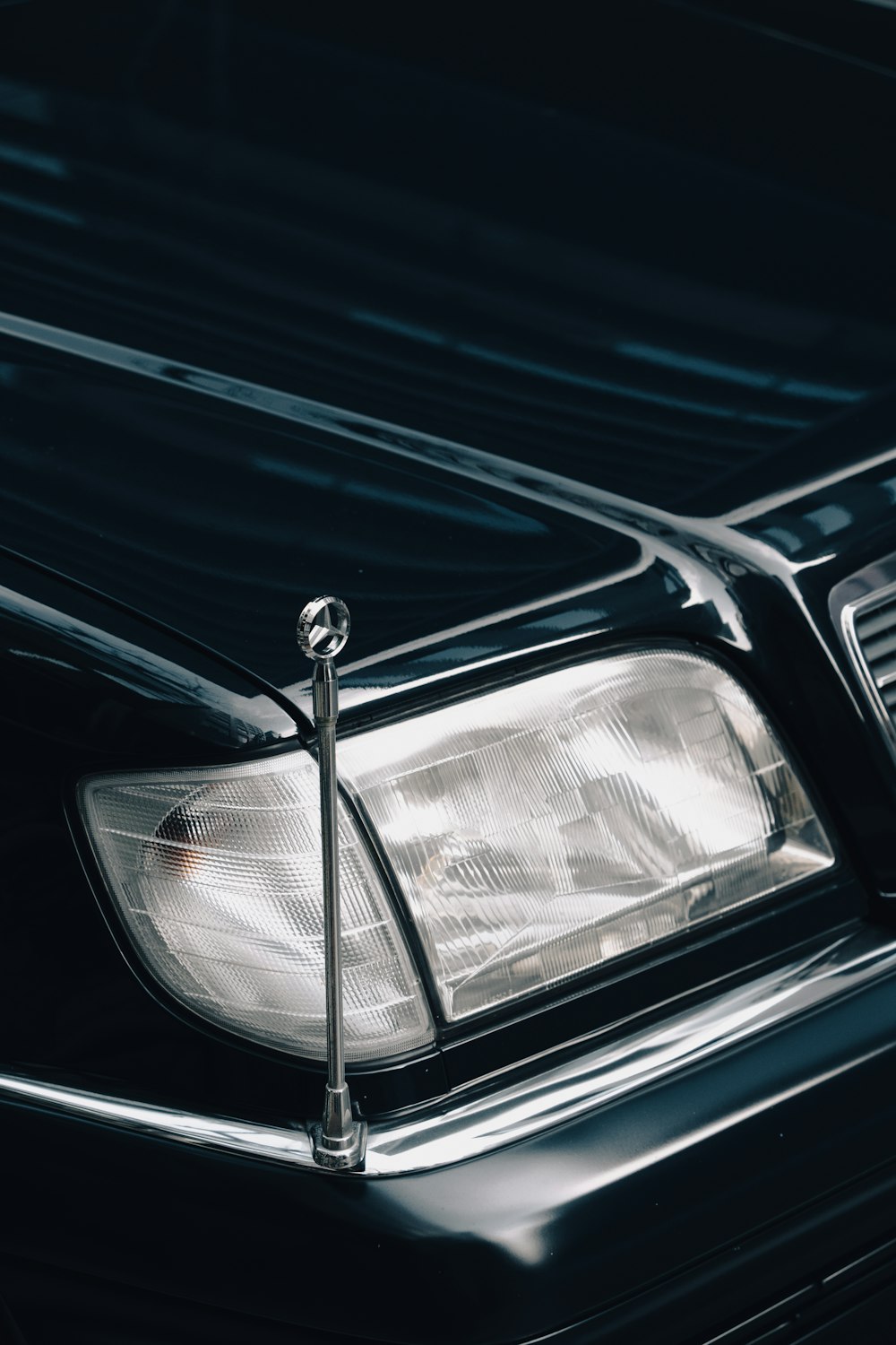 a close up of a car headlight on a black car