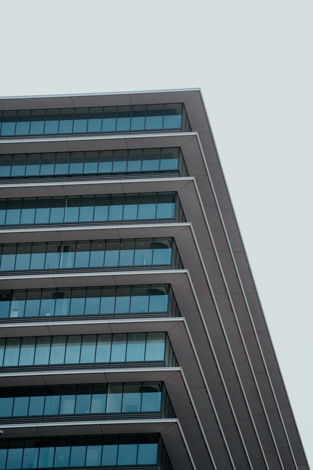 an airplane flying in the sky over a building