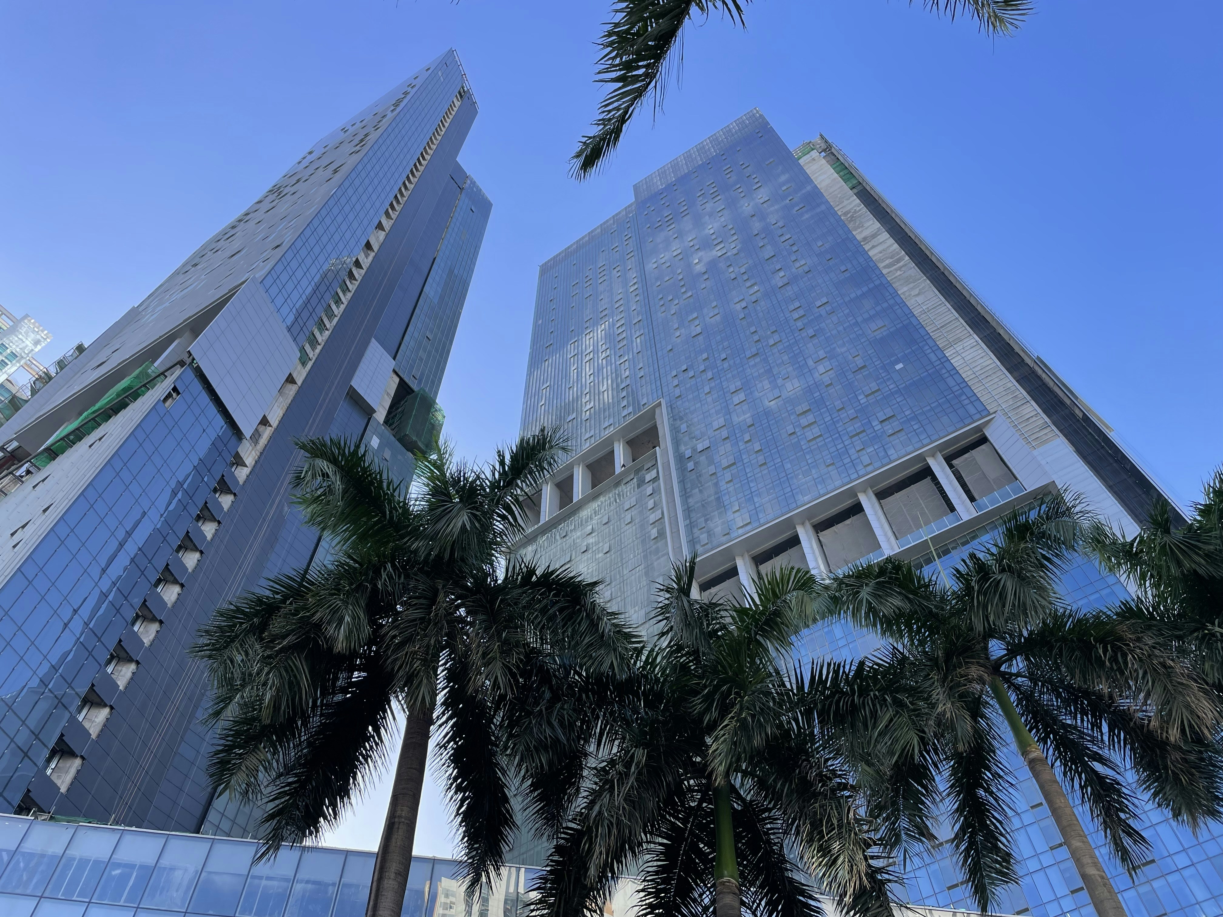 a couple of tall buildings sitting next to each other