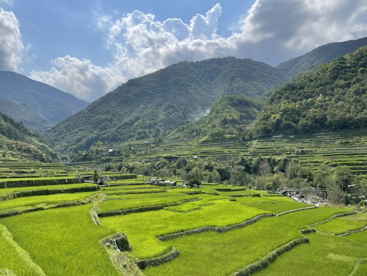 A lush green field with mountains in the background — Banaue & the rice terraces, Philippines
