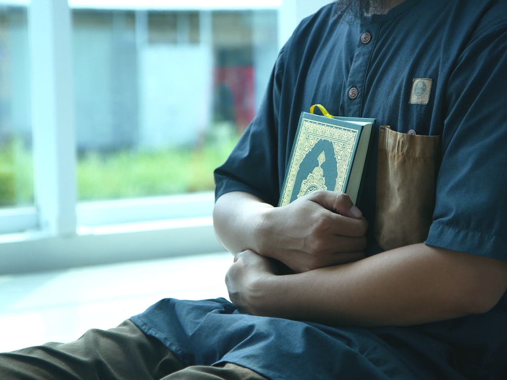 a man is holding a bag and a book