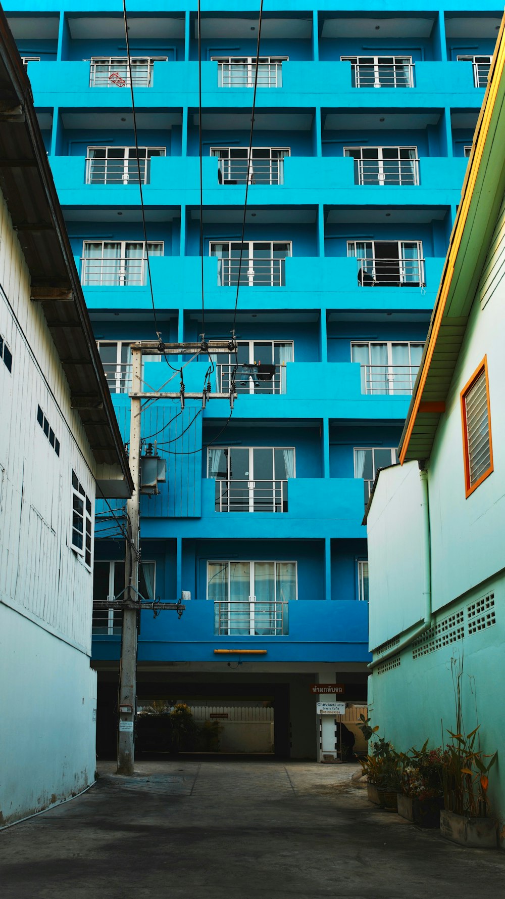 a tall blue building sitting next to a tall white building