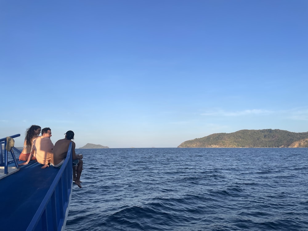 a group of people sitting on top of a boat