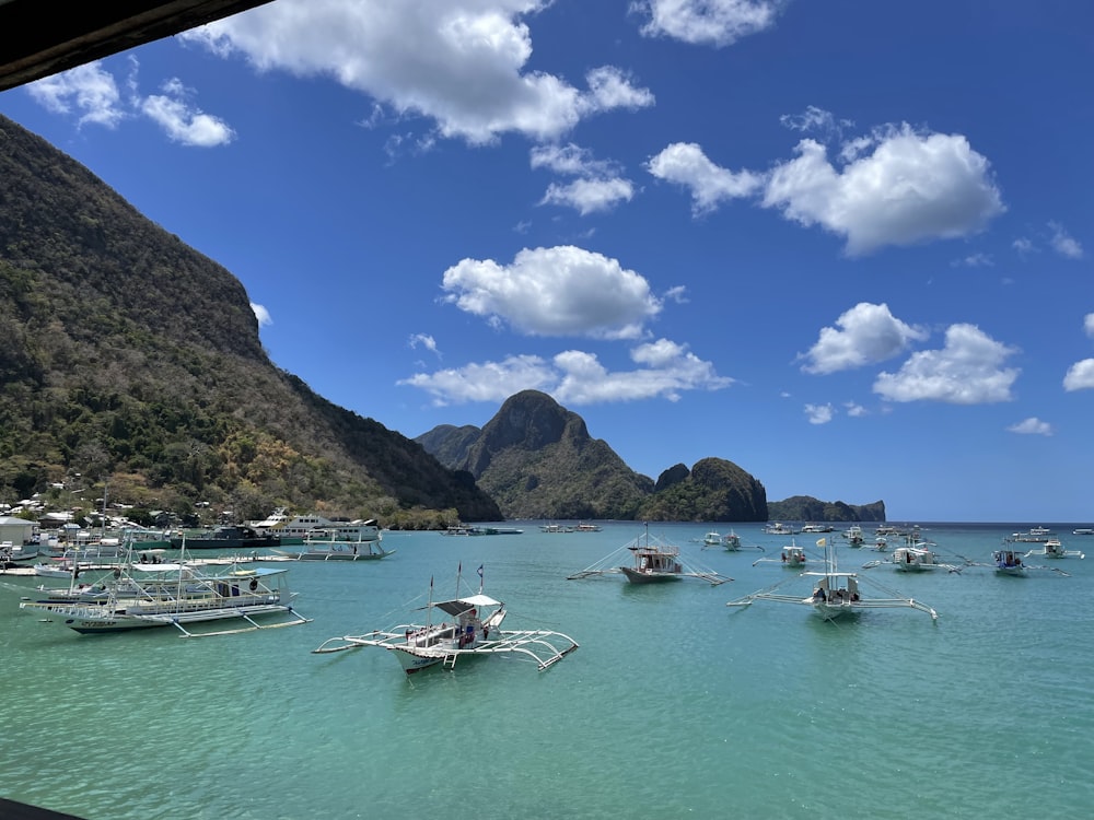 a group of boats floating on top of a body of water