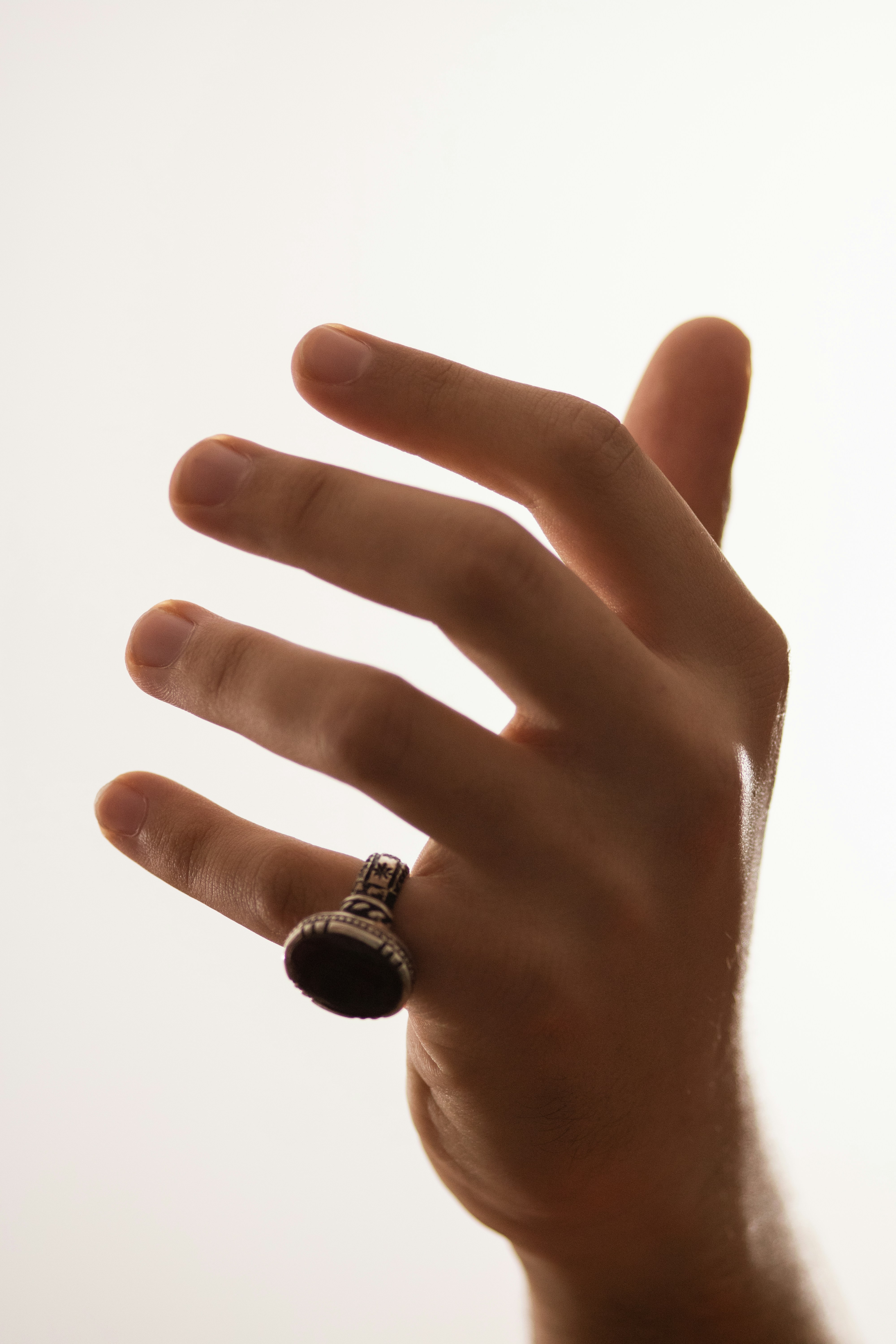 a person's hand with a ring on it