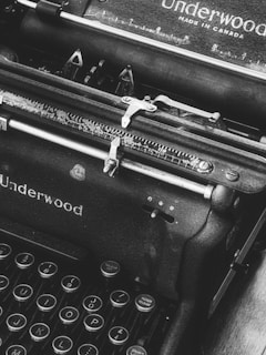 a black and white photo of an old fashioned typewriter