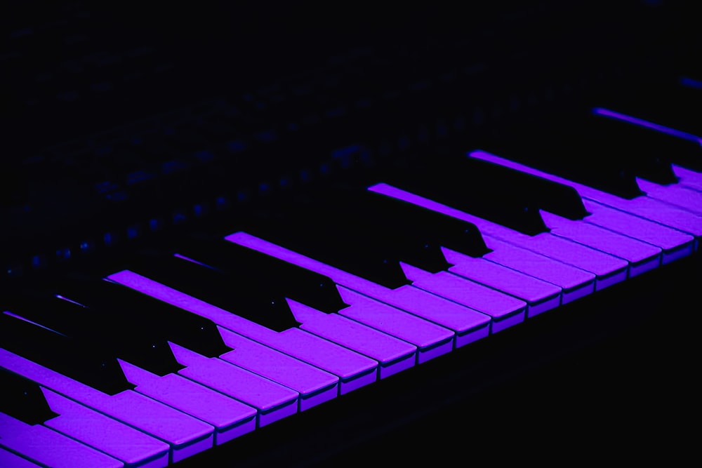 a close up of a purple piano keyboard