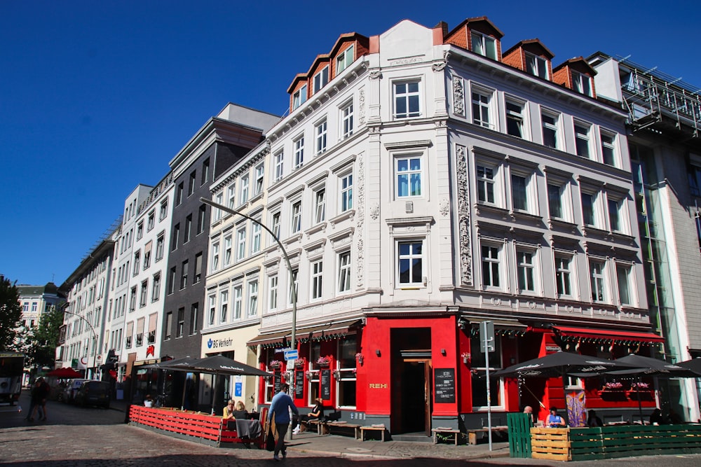 a large white building with people walking around it