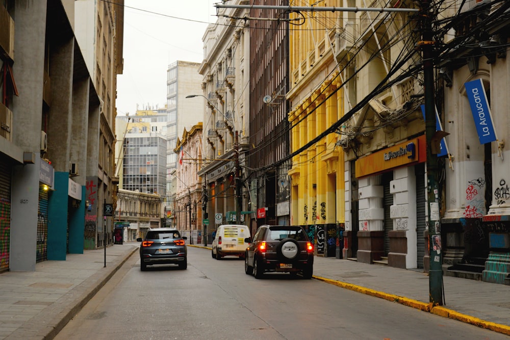 a couple of cars that are sitting in the street