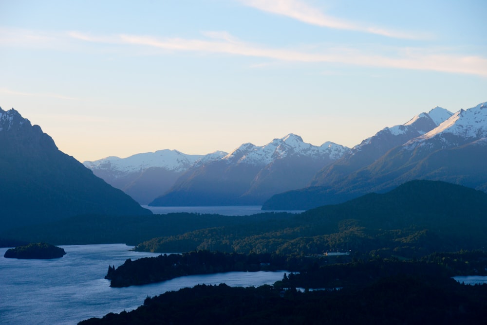 a view of a mountain range with a lake in the foreground