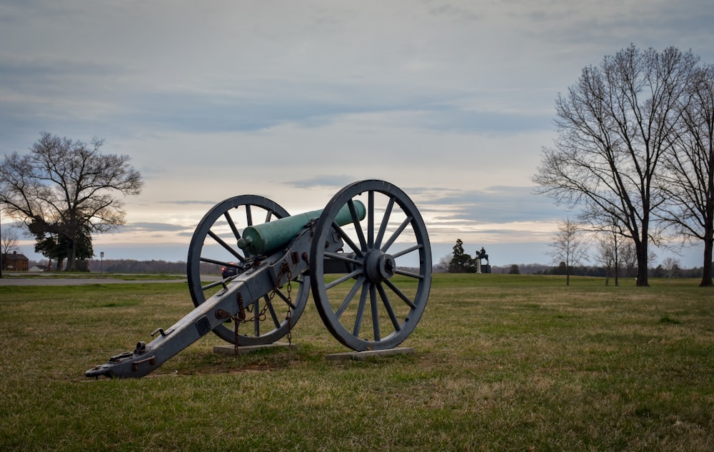 a cannon sitting on top of a grass covered field