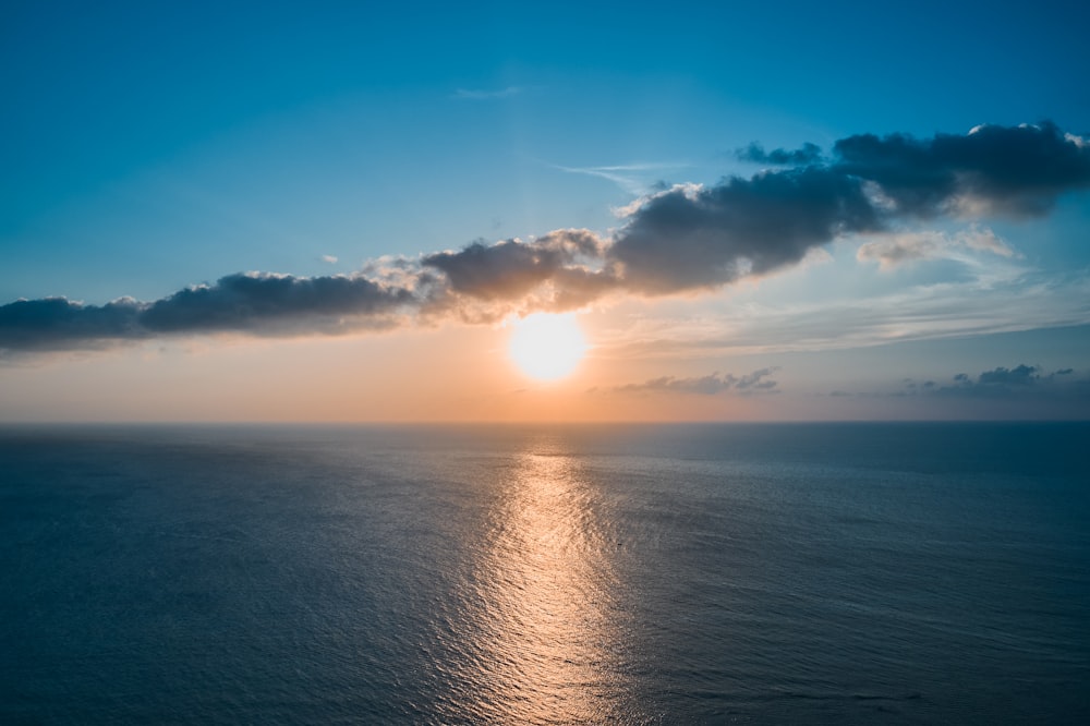 a large body of water under a cloudy sky