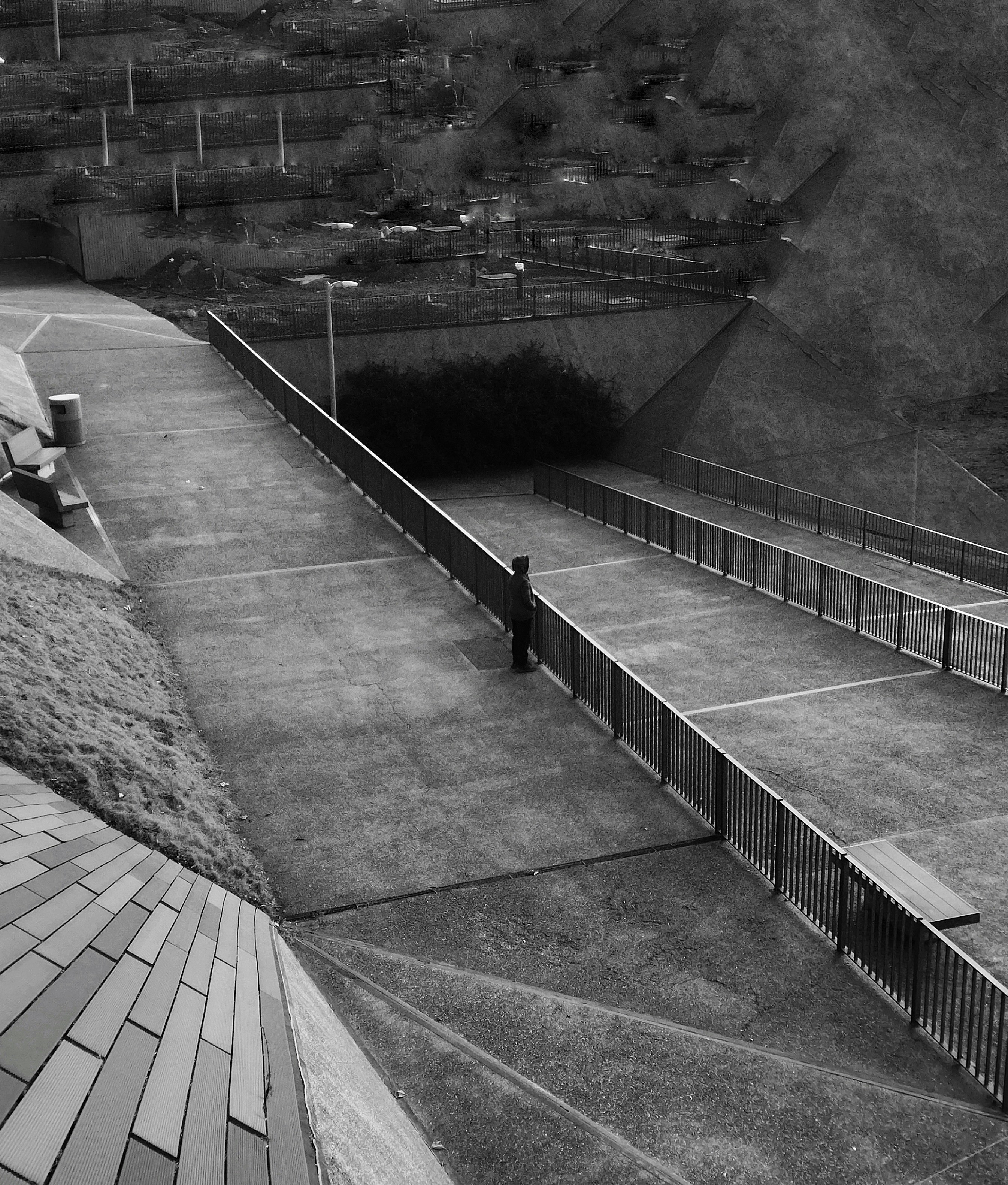 a black and white photo of a person on a tennis court