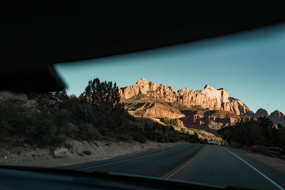 a view of a mountain from inside a car