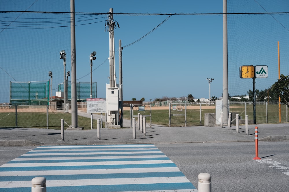 a street with a crosswalk and a yellow traffic light