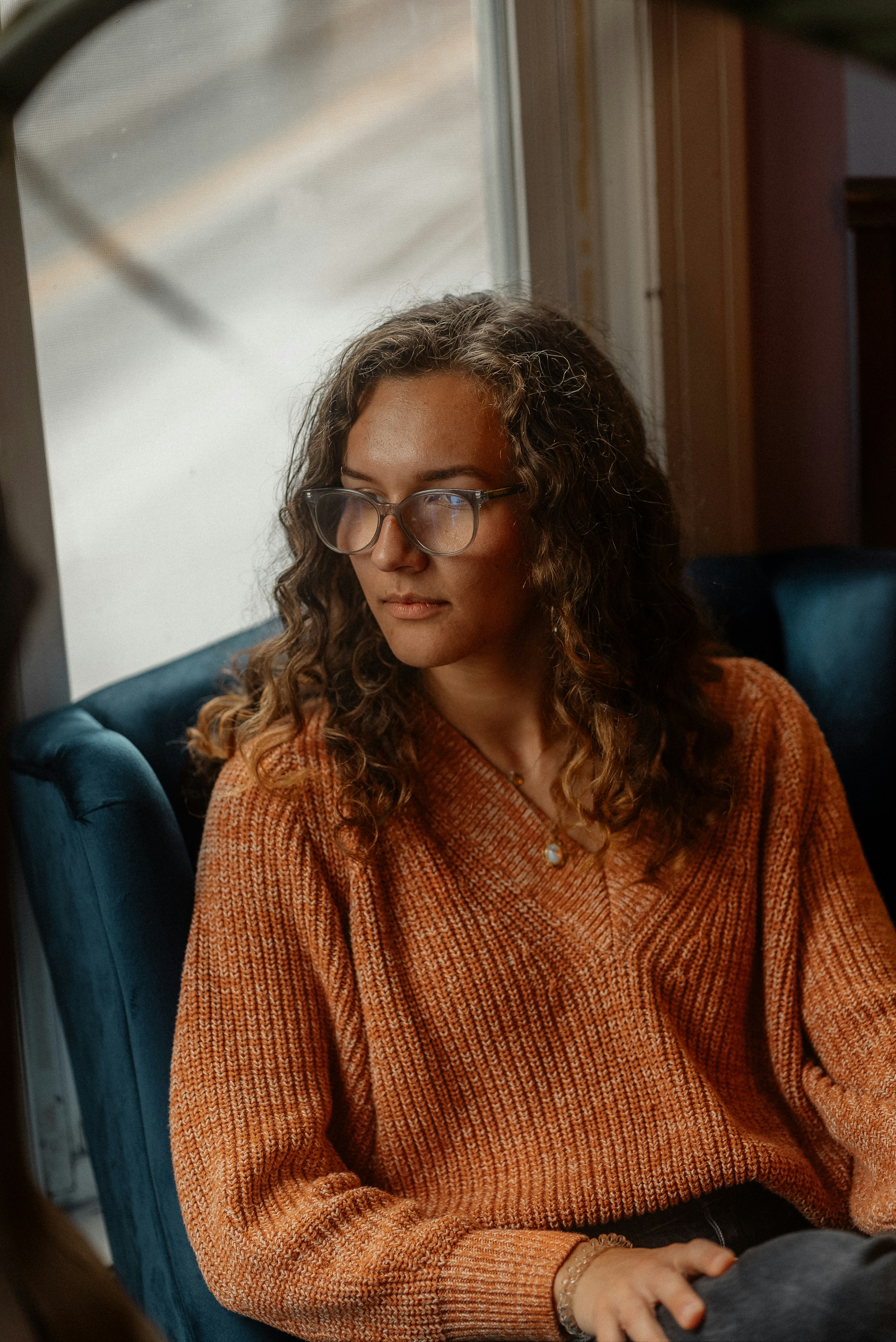 a woman sitting in a chair with a cell phone in her hand