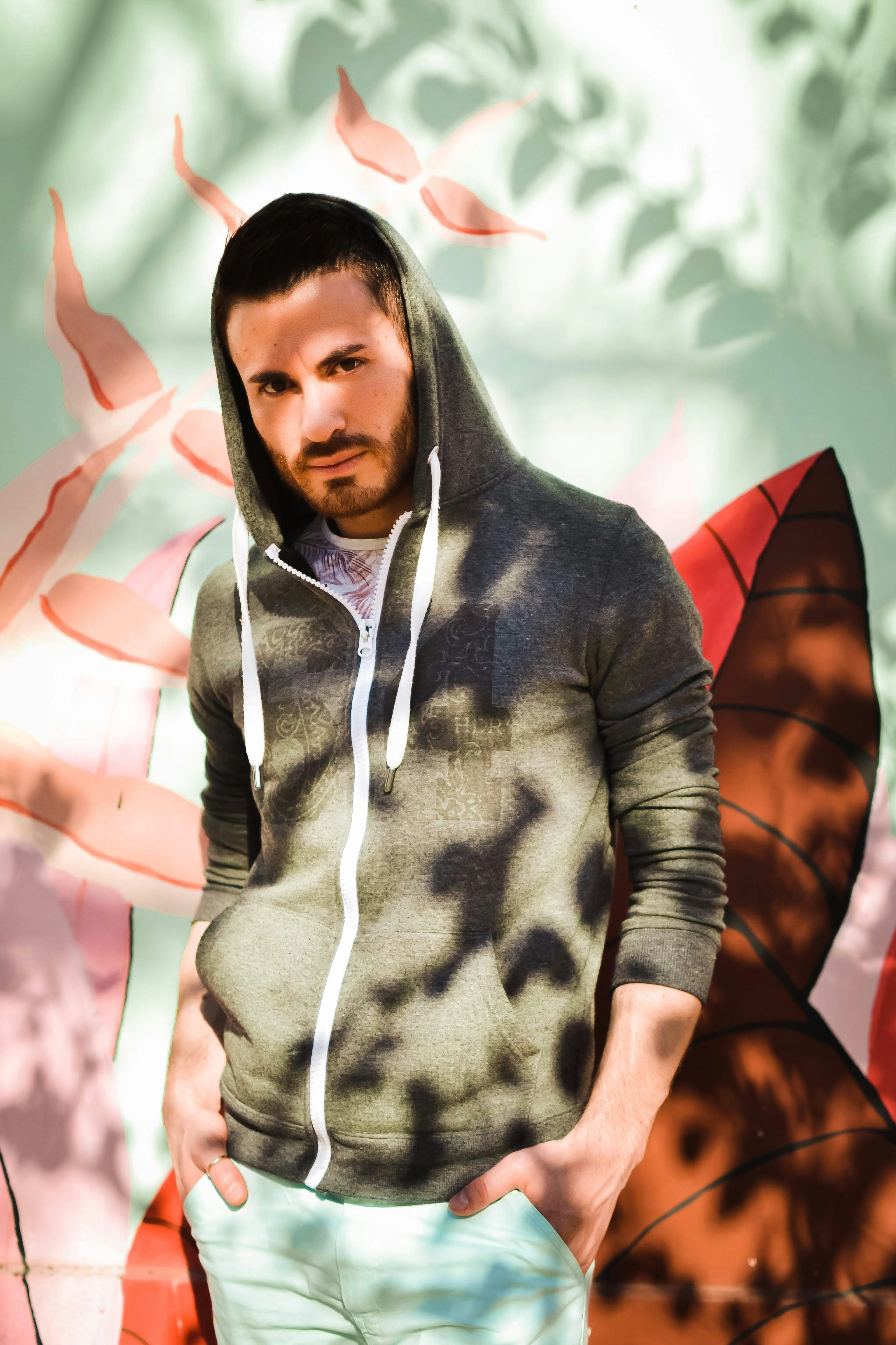 a man standing in front of a painting of a butterfly