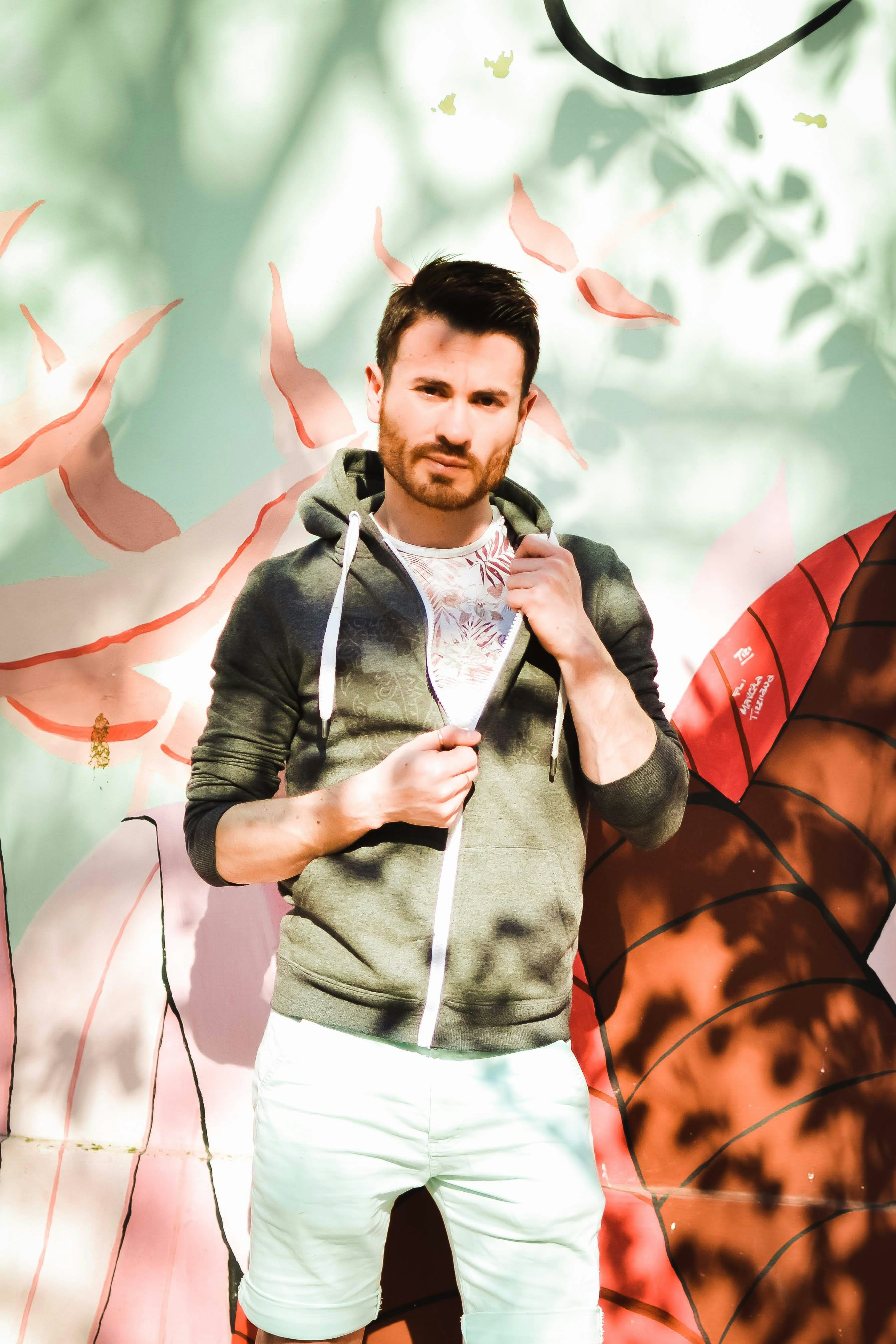 a man is standing in front of a painting