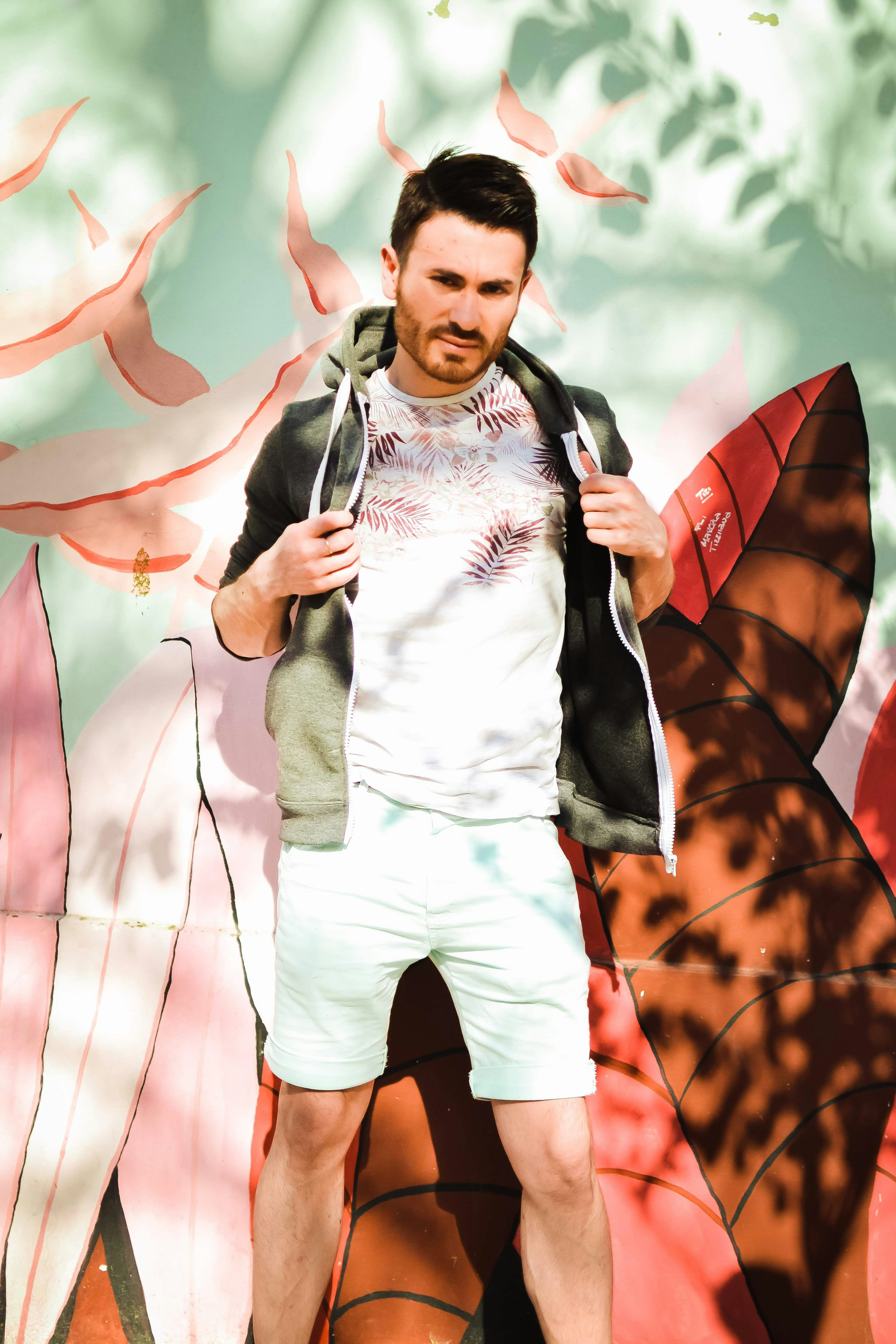 a man standing in front of a colorful wall