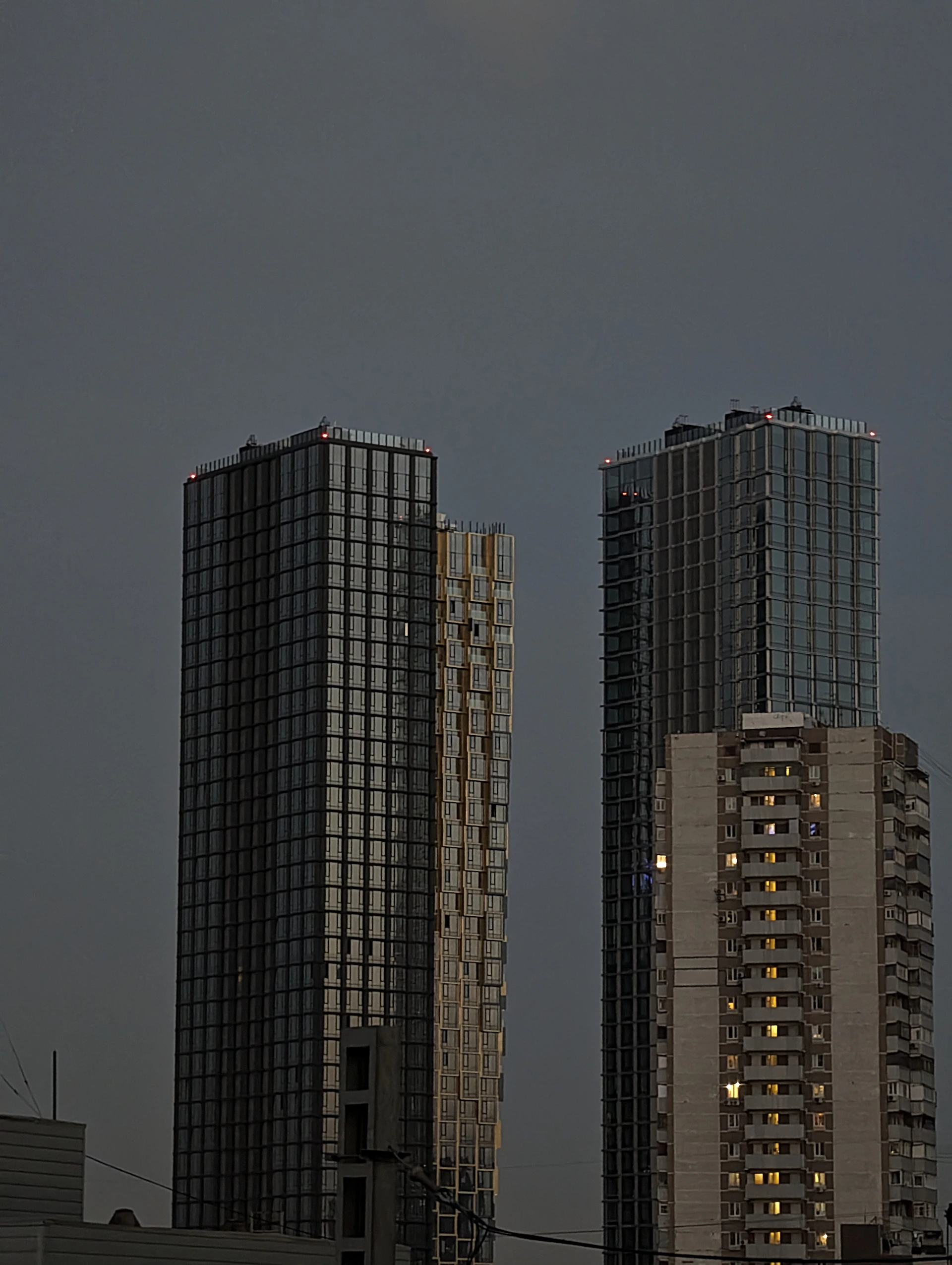 a couple of tall buildings sitting next to each other