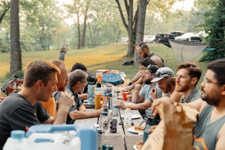a group of people sitting around a picnic table