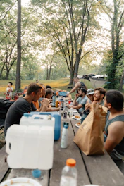 a group of people sitting at a picnic table