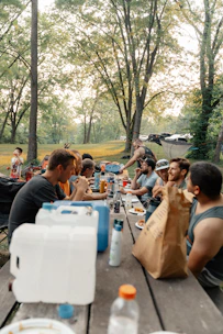 a group of people sitting at a picnic table