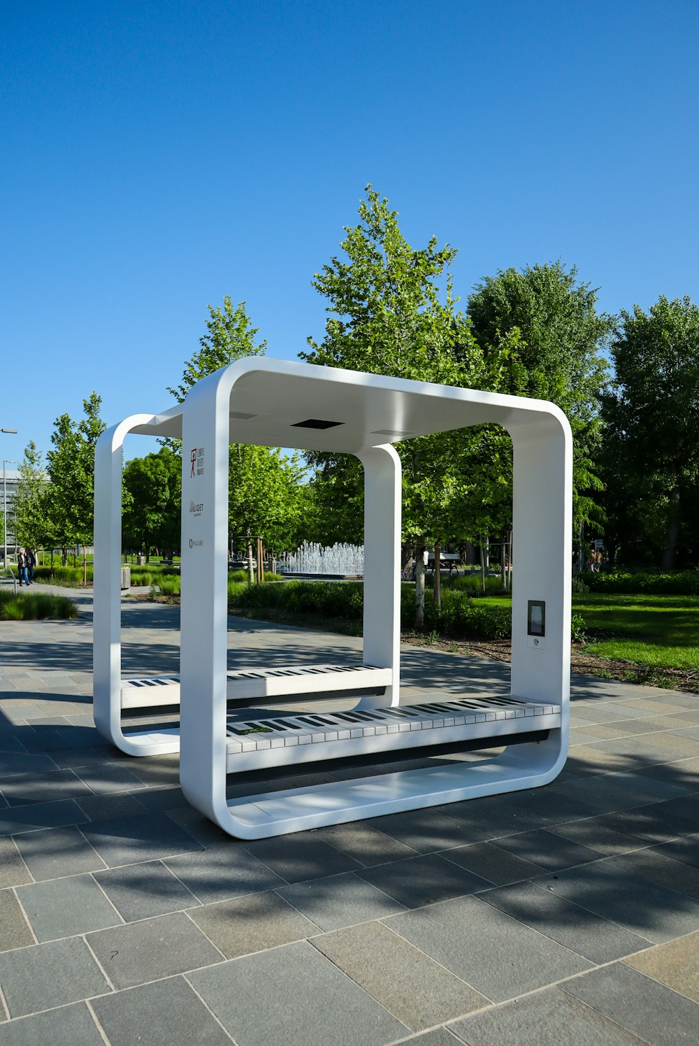 a white bench sitting in the middle of a park