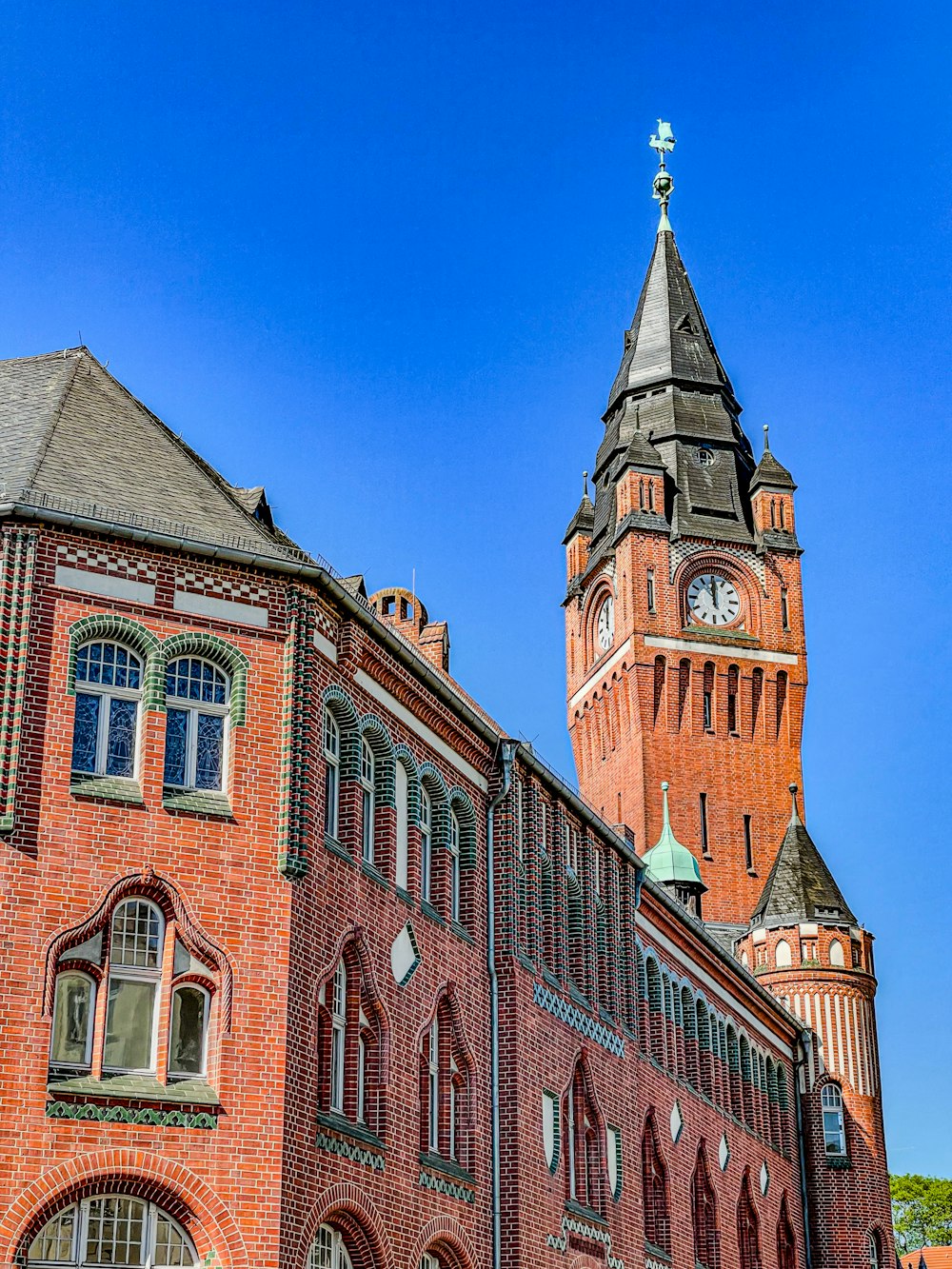 a large red brick building with a clock tower