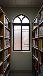 a window in a library filled with lots of books