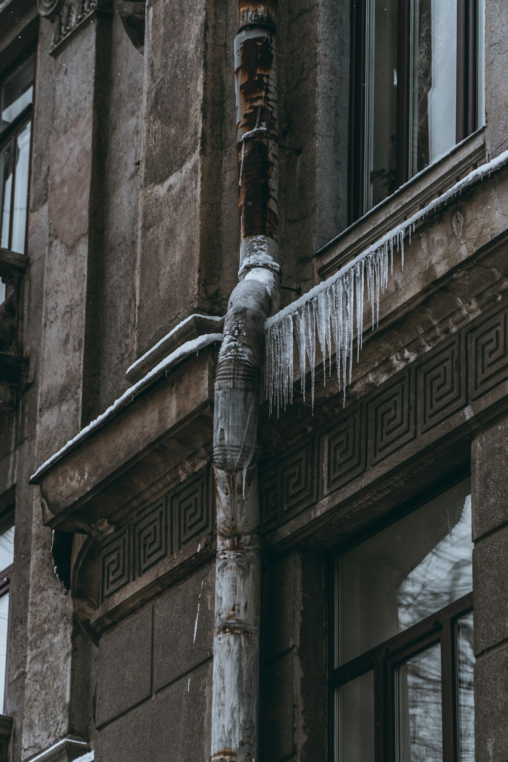 an old building with icicles hanging off of it's side