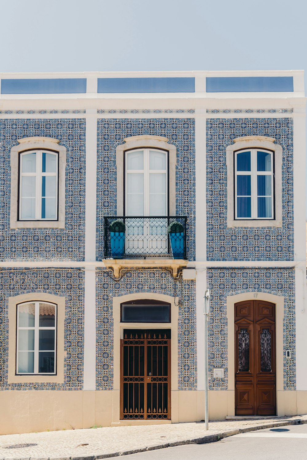 a blue and white building with a brown door